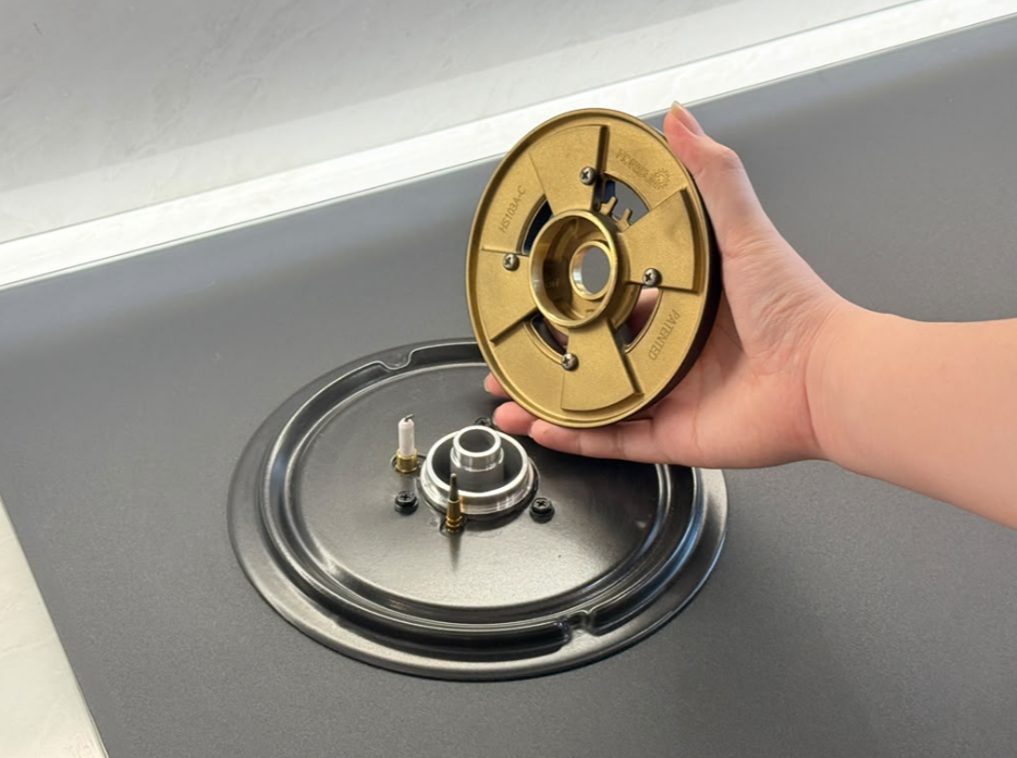 Removing a gas hob burner cap for cleaning and maintenance