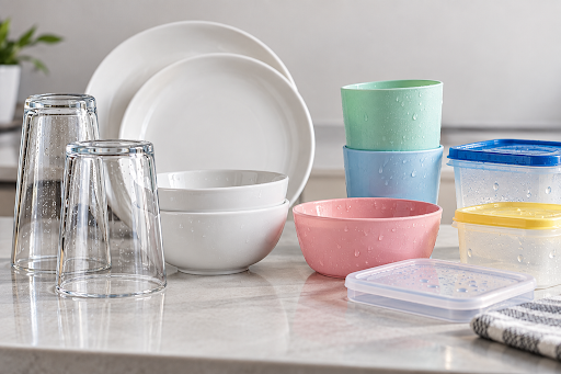 Plastic containers and utensils remaining wet after dishwasher cycle due to lower heat retention compared with glass and ceramic dishes